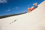 Sand tobogganing sand boarding Moreton Island